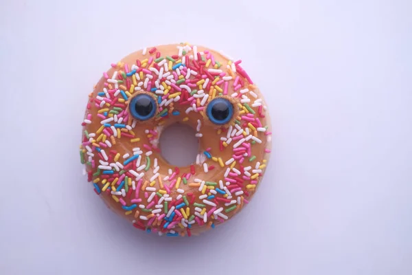 Closeup of donut with funny face on white background — 스톡 사진