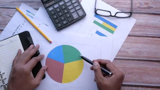 Top view of man hand analyzing chart on desk — Stock Video