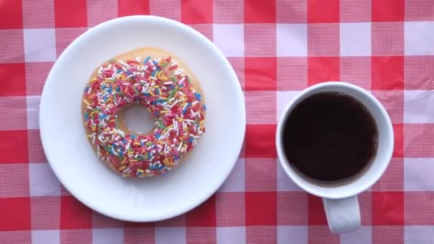 Top view of donuts and coffee on table for breakfast. — Stockvideo