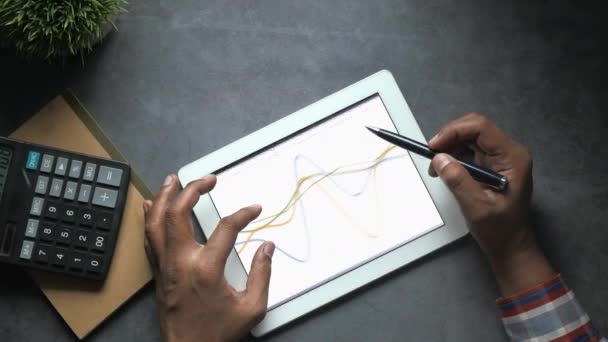Vista superior del hombre de negocios analizando gráfico en tableta digital — Vídeo de stock