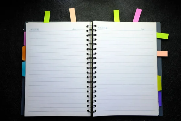 Top view of open notepad on black background — Stock Photo, Image