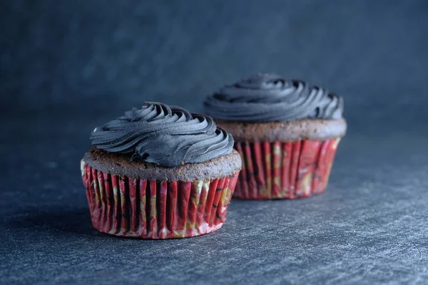 Nahaufnahme von frischem und hausgemachtem Cupcake auf Tisch, auf schwarzem Hintergrund — Stockfoto