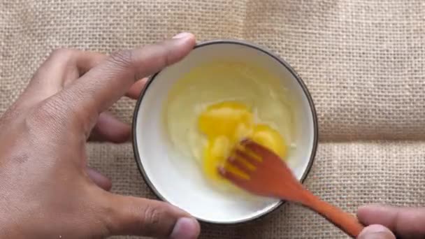 Top view of egg in a bowl on table — ストック動画