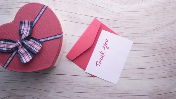 Top view of valentine day gift and envelope on table — 图库视频影像