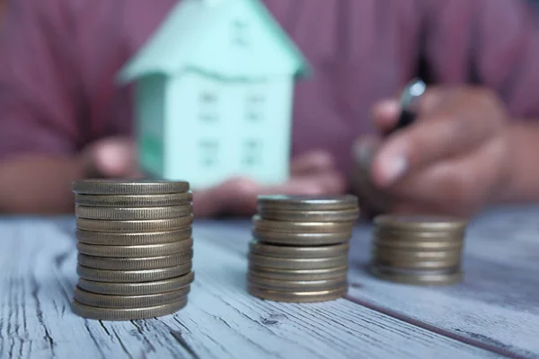 home finance concept with coin and house on table