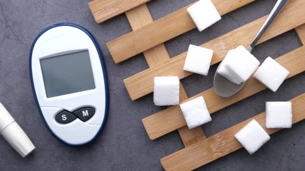 Diabetic measurement tools and sugar cube on table — Stock Video