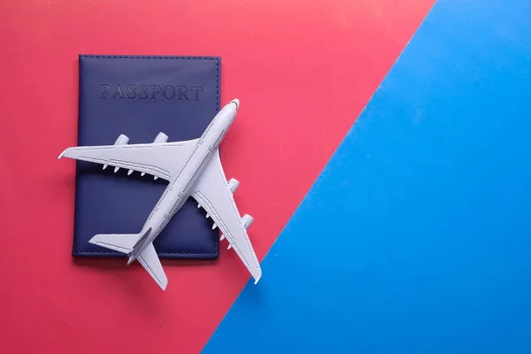 traveling and tickets booking concept with airplane and passport