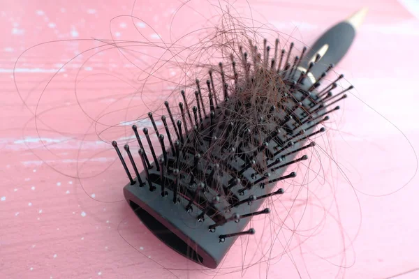 Primer plano de las mujeres cabello en el cepillo — Foto de Stock