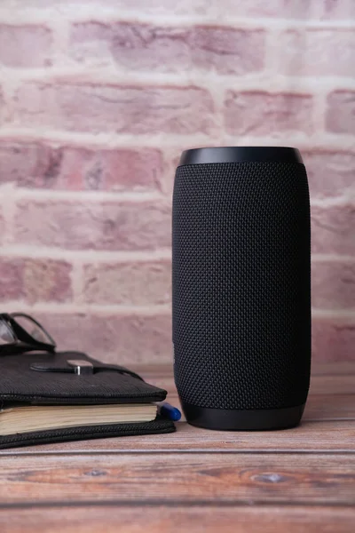 Close up of smart speaker on table against wall