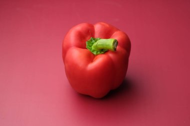 Close up of red capsicum on red background 