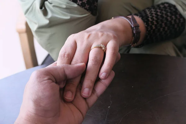 Junges Paar hält sich an der Hand, Nahaufnahme — Stockfoto