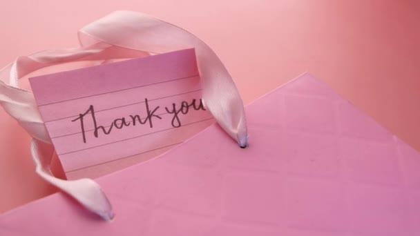 Thank you message with gift box on pink background — Stock video