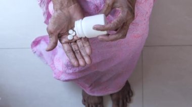 Yaşlı kadınların avucundaki hapların üst görünümü 