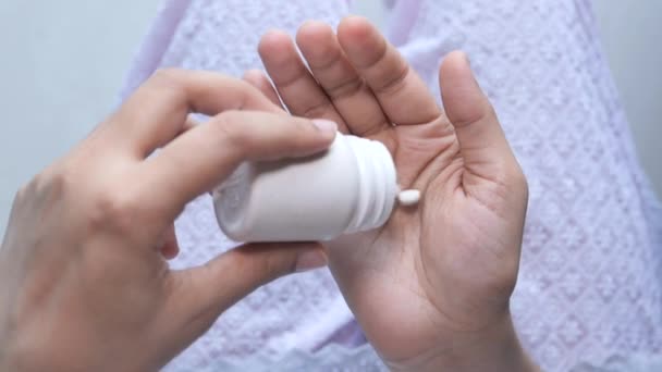 Close-up van pillen gieten op palm van vrouwen hand — Stockvideo
