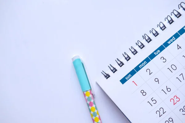 Top view of calendar, pen on white background — Stock Photo, Image