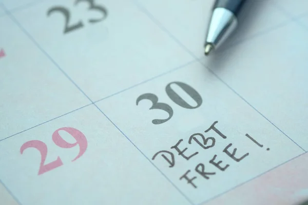 Debt Free word on calendar date, close up