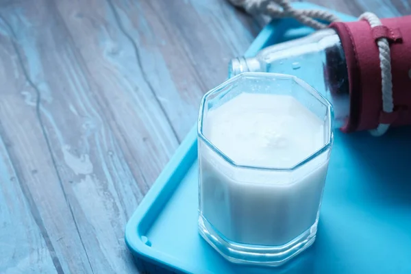 Produits laitiers. Bouteille avec lait et verre de lait sur table en bois . — Photo