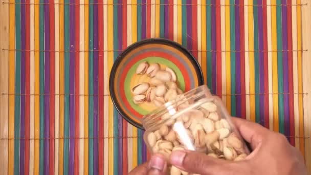 High angle view of pistachios nuts in a bow. — Stock Video