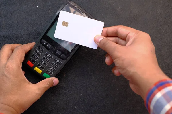 Payment terminal charging from a card, close up