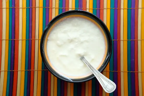 Greek yogurt in a wooden bowl on a rustic wooden table. — Stock Photo, Image