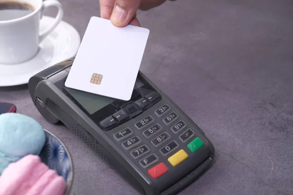 Payment terminal charging from a card, close up