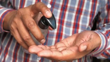 Erkek eli dezenfektan jel makinesi kullanıyor.