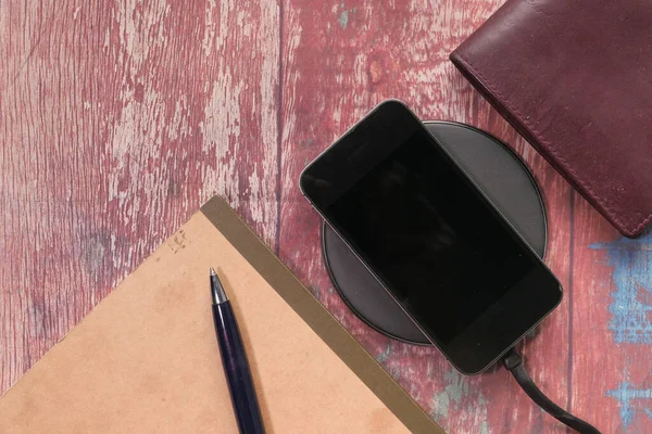 Top view of smart phone charging on table. — Stock Photo, Image