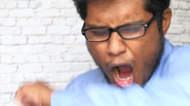 Adam dirseğiyle ağzını kapatırken öksürüyor ya da hapşırıyor. .