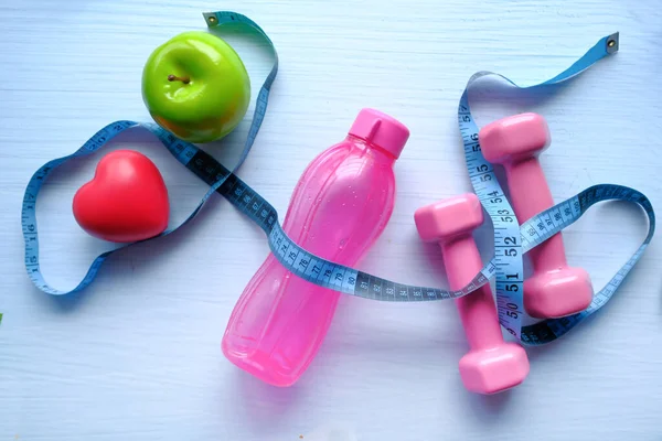 High angle view of water bottle, apple and dumbbell on table — Stock Photo, Image