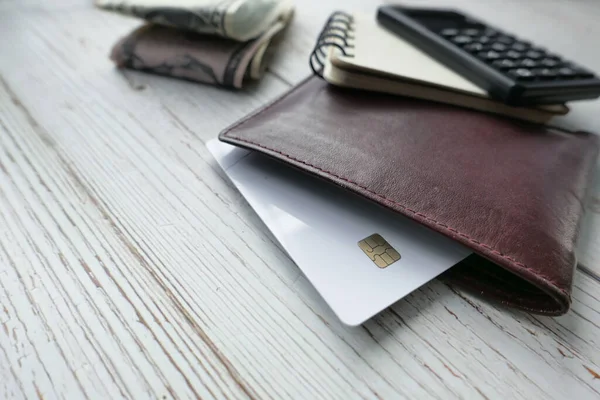 credit card in a wallet on wooden table