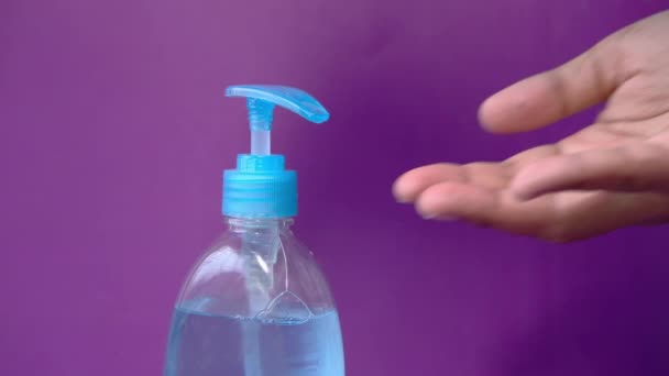 Hands of young man using hand sanitizer — Stock Video