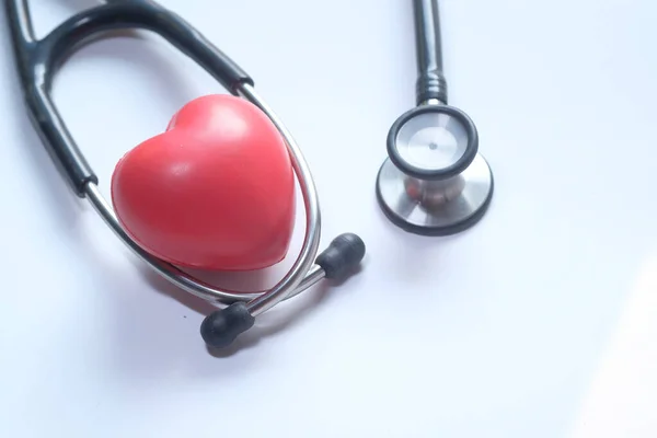 Red heart and a stethoscope on a white background — Stock Photo, Image