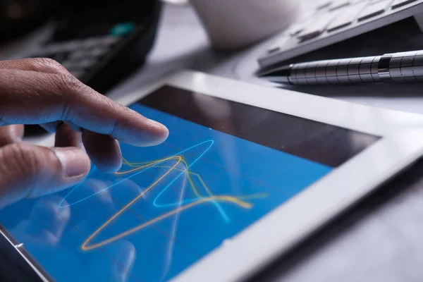 person hand analyzing financial data on digital tablet