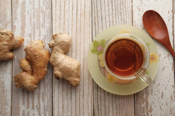 Ginger tea with ginger on table , high angle view .