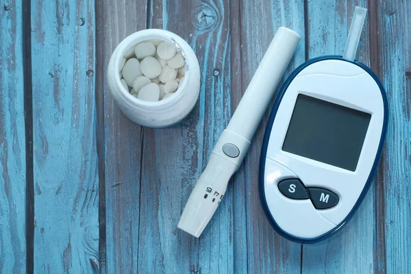 stock image  blood sugar measurement kits for diabetes on wooden background 