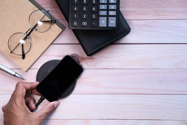 charging Smartphone Using Wireless Charging Pad, top view