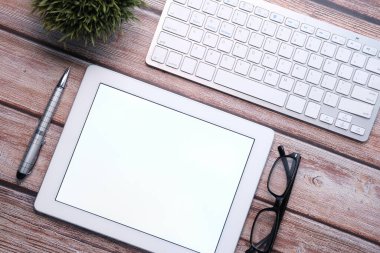 Ofis masasında ekranı olan dijital tabletin üst görünümü 