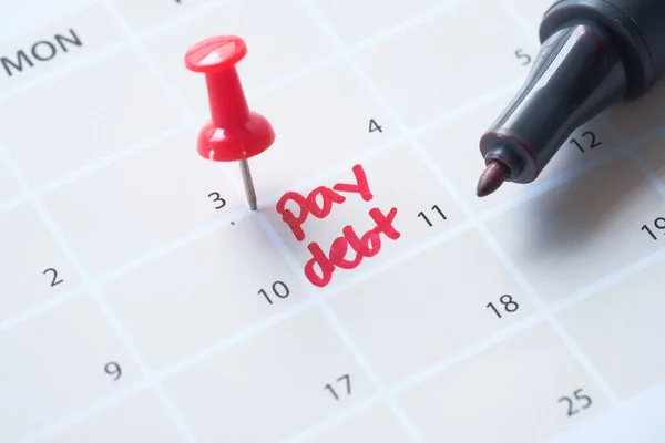 Close up of pay debt word on calendar — Stock Photo, Image