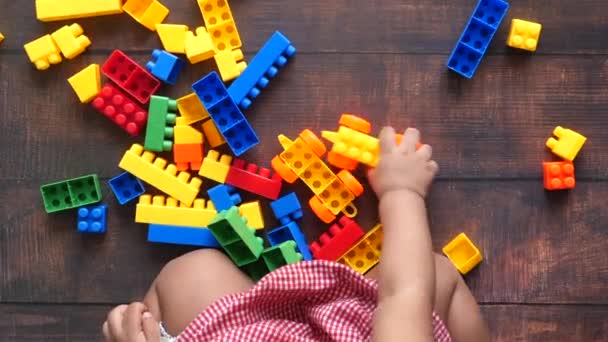 Child girl paying with with building blocks on floor — Stock Video