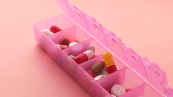 Top view of colorful pills in a pill box — Stock Video