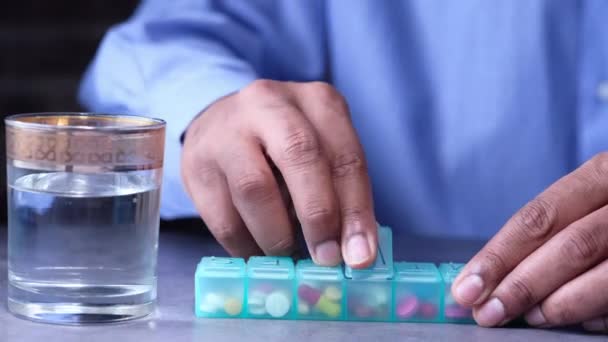 Young man hands taking medicine from pill box — Stock Video