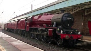 Preserved steam locomotive Galatea at  the head of the Winter Cumbrian Mountain Express in Penrith station, on the English west coast mainline.