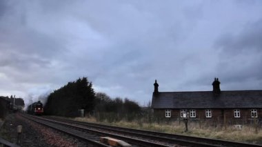 Two preserved steam locomotives head the Winter Cumbrian Mountain Express into Lazonby station, on the Settle to Carlisle railway in northern England.