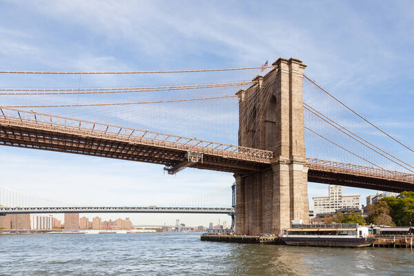 A close up view of Brooklyn Bridge in New York City in the United States of America. In the background can be seen Manhattan Bridge and beyond that Williamsburg Bridge.