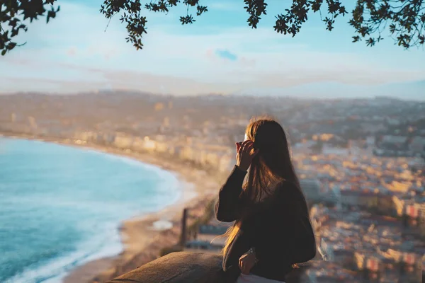 young female watching sunset in Nice, France. beautiful panoramic aerial cityscape top view of Nice, of French riviera. Landscape of harbor, town of Cote d\'Azur France. long hair woman enjoying evening near sea.