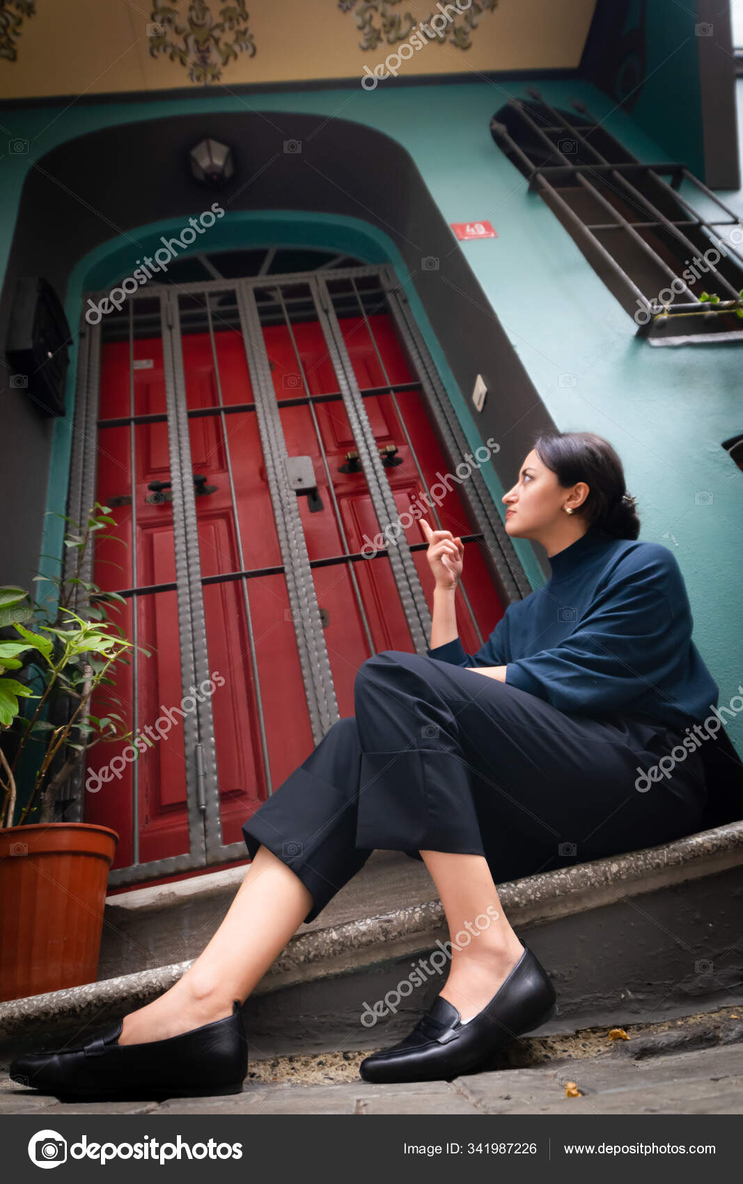 Woman in blue denim jeans sitting on stairs photo – Free Pants Image on  Unsplash
