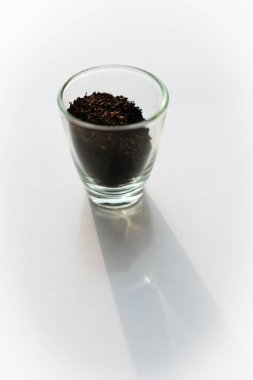 turkish black tea on display in a small cup with empty white background.