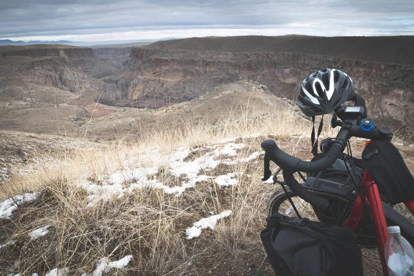 Close up background image of red touring bicycle with accessories and dramatic views and landscape  of Ihlara valley.