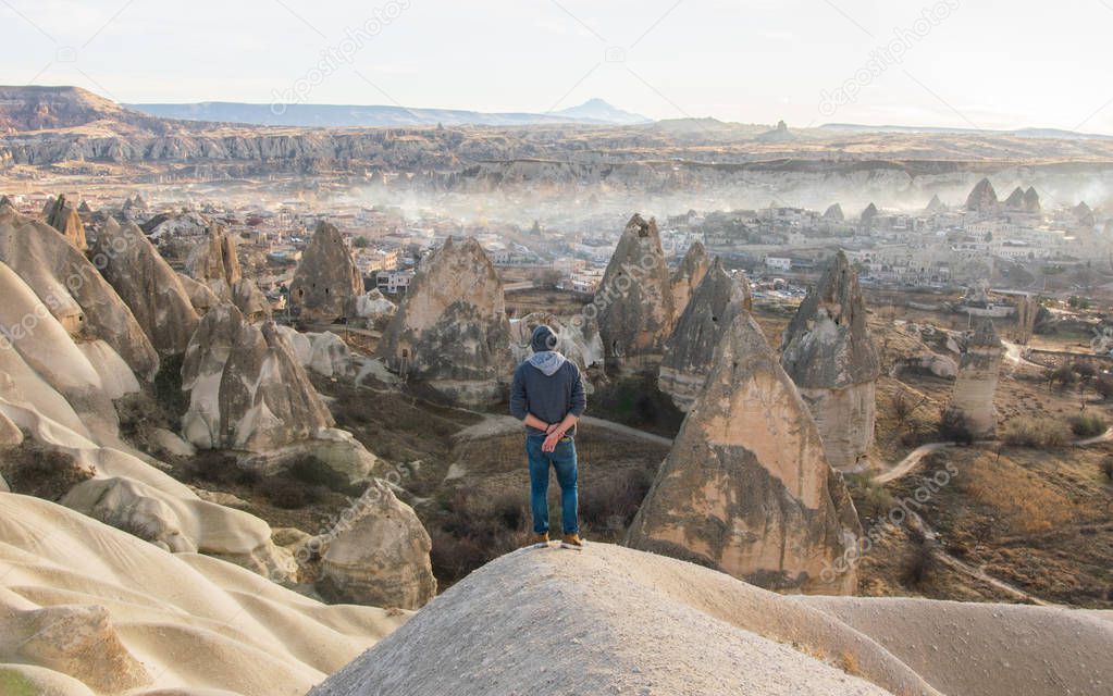 Thinking man with crossed hands over back is admiring morning views of Goreme.Kapadokya.Turkey. Conception of new beginning Exploring Turkey.2020.