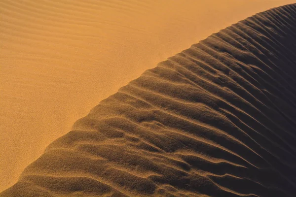 Textures and shades of golden sand in a desert